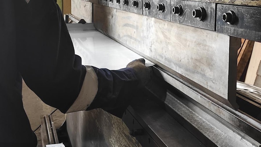 Press brake operator forming a replacement metal section at a Columbus, Ohio fabrication shop