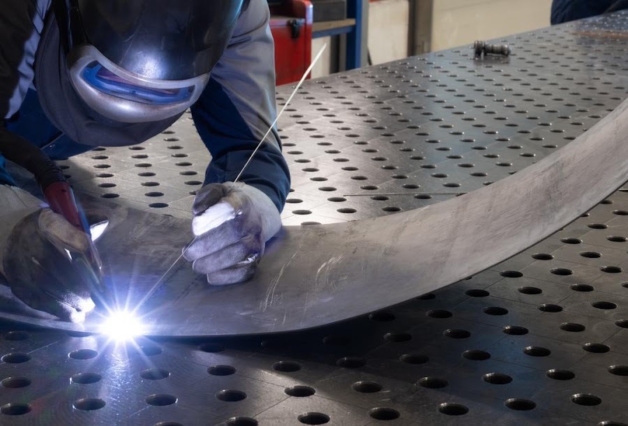 aluminum welding in Columbus Ohio - TIG welding a curved metal panel seam at a Columbus Ohio fabrication shop