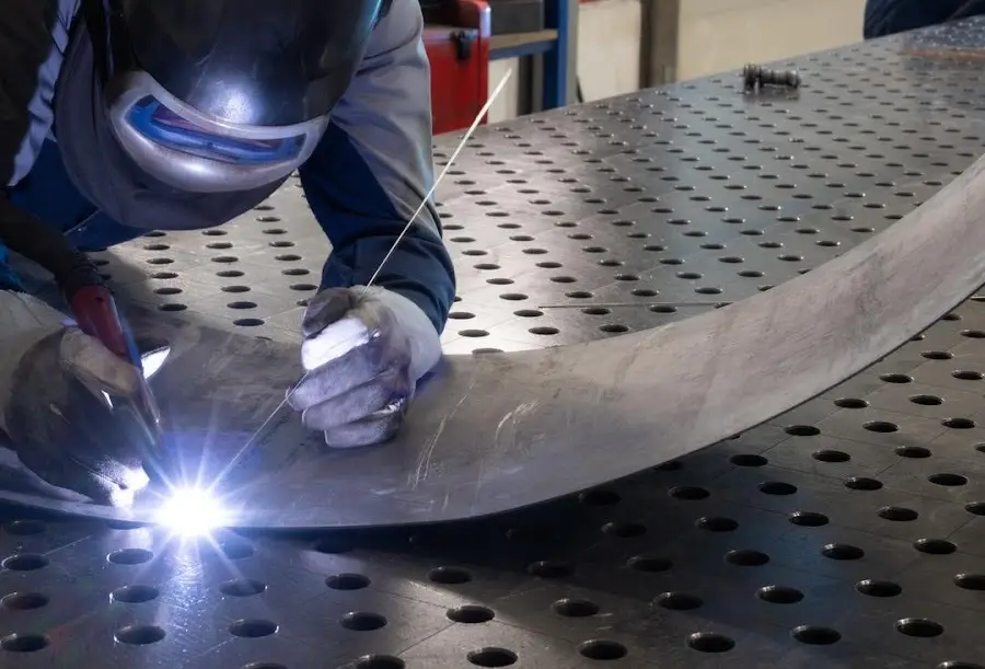 aluminum welding in Columbus Ohio - TIG welding a curved metal panel seam at a Columbus Ohio fabrication shop